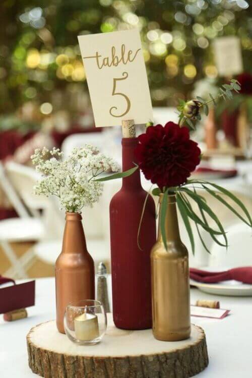 Wildflower nature wedding centerpieces with wood slices, bottles