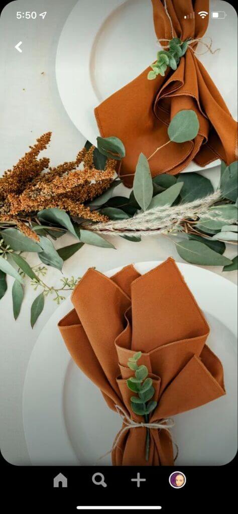 wedding table setting with burnt orange napkins