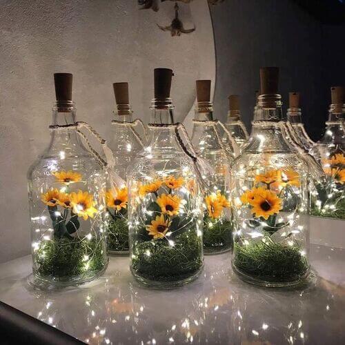 centerpiece in a bottle with sunflowers