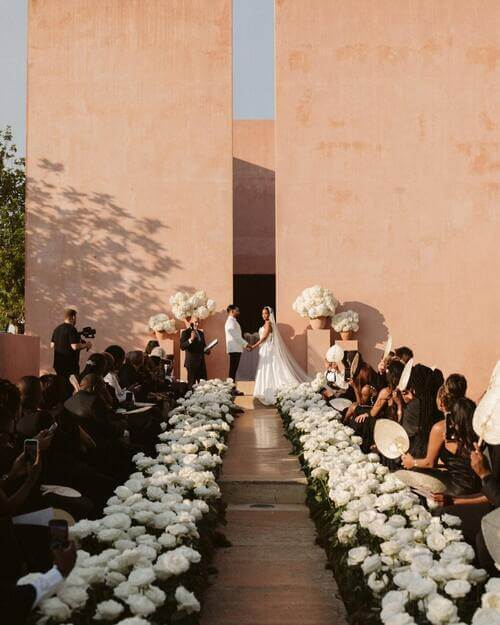 Black and whit themed wedding aisle and guest attire