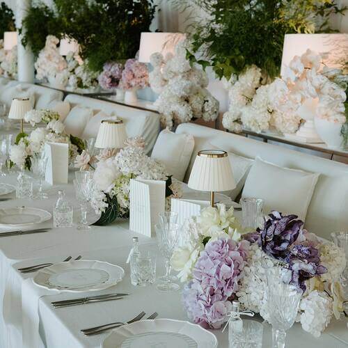 Black and white themed wedding white table setting with pops of color