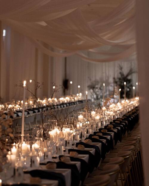 Black and white themed wedding white table setting with roses and candles