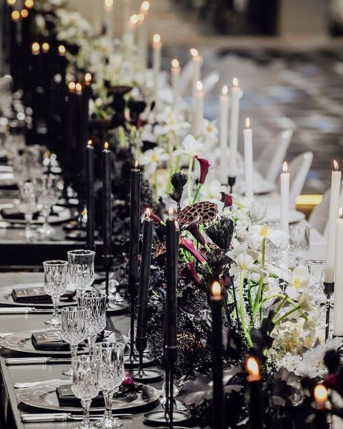 Black and white themed wedding table setting with candles