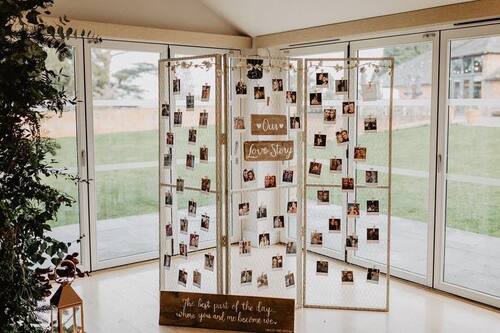Photo display at wedding on divider