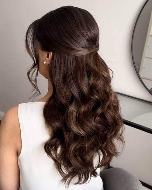 Half up half down curly bridal hairstyle brunette