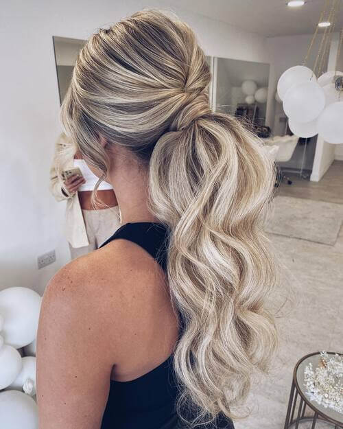 Low ponytail with curls bridal hairstyle
