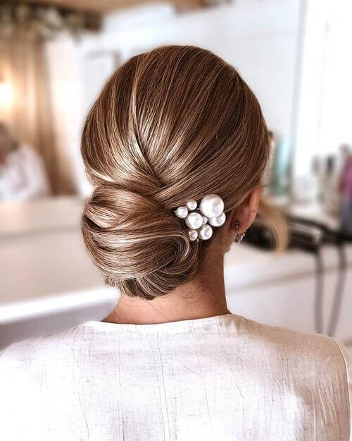 Low braided bun with pearl hairclip