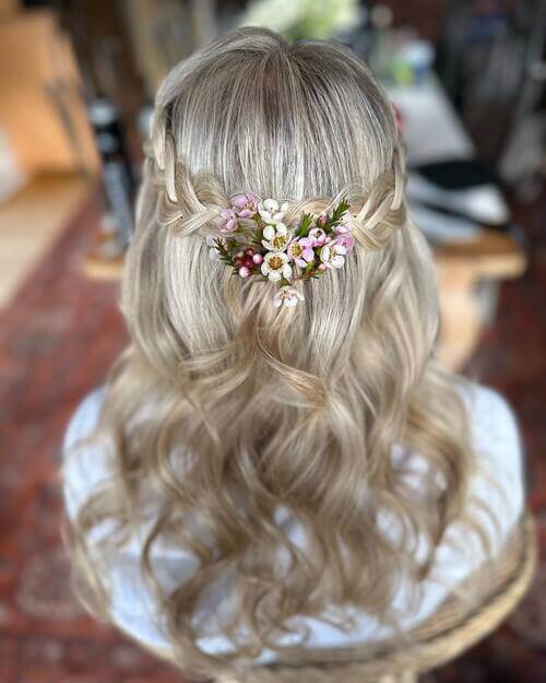 Floral hair piece braided bridesmaid hairstyle