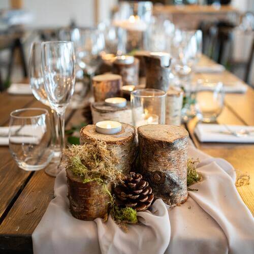 Rustic wedding table center piece tree stumps and pine cones