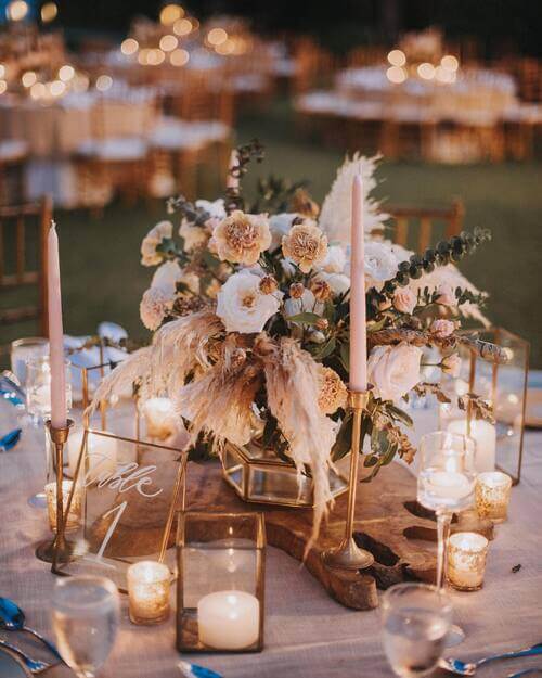 Rustic wedding table center piece candles and flowers
