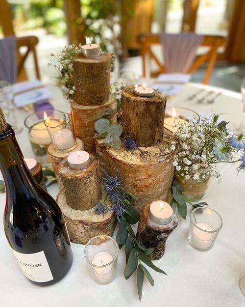 Rustic wedding table center piece with tree stumps