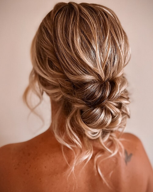 Low twisted bun romantic wedding hairstyle 