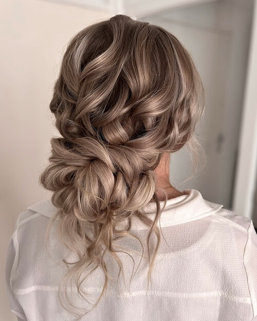 Messy bun with curly hair romantic wedding hairstyle