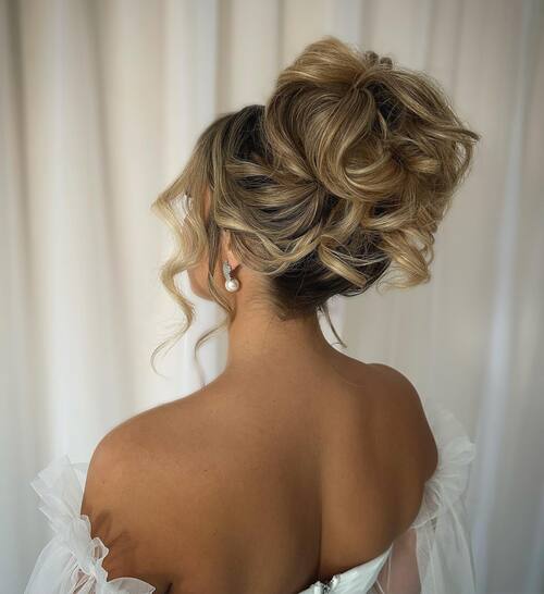 High messy bun romantic wedding hairstyle