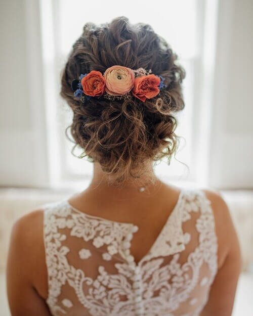 Floral hairpiece romantic wedding hairstyle