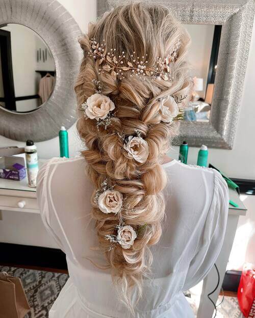 Braid hairstyle with roses romantic wedding hairstyle