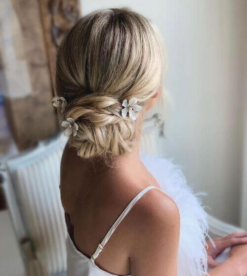 Wedding up-do simple with floral hair pieces